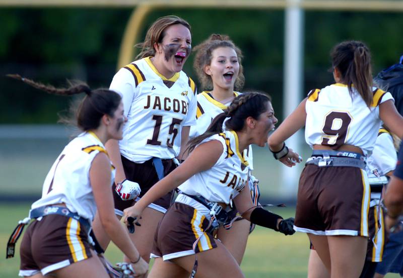 Jacobs’ Golden Eagles celebrate their win in varsity flag football on Tuesday, Sept. 3, 2024, at Dundee-Crown High School in Carpentersville.