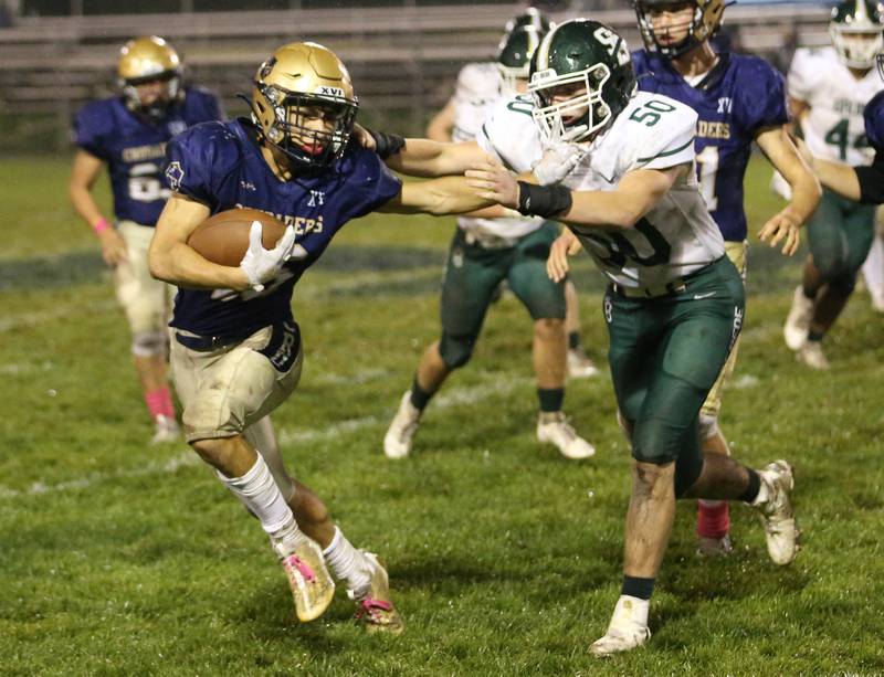 Marquette's Payton Gutierrez stiff-arms St. Bede's Jake Miglorini on Friday, Oct. 13, 2023, at Gould Stadium.