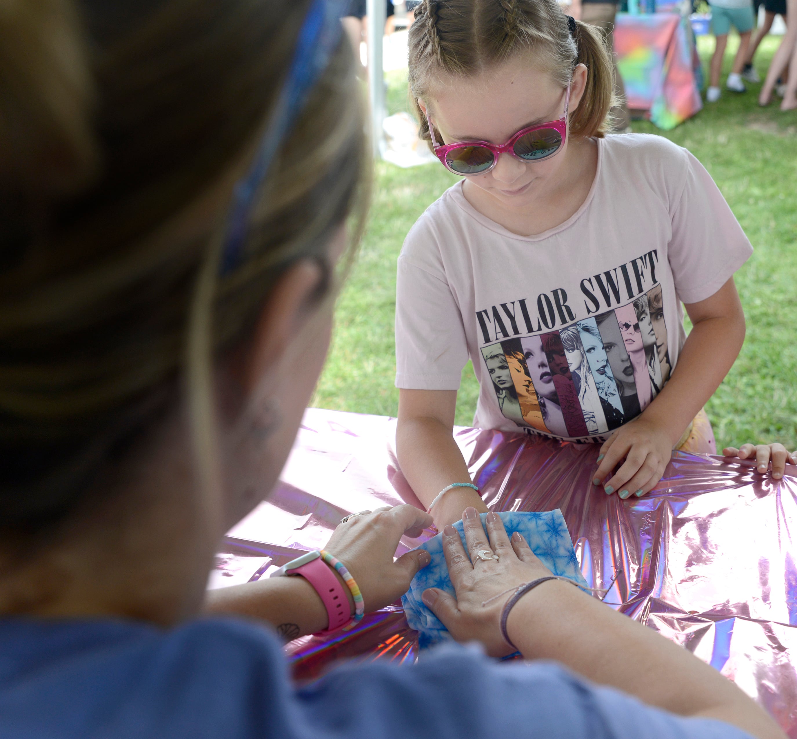 Mila Lyle has a temporary tattoo applied Sunday during the Taylor Swift Dance Party in Ottawa. The event was part of Friendship Days.