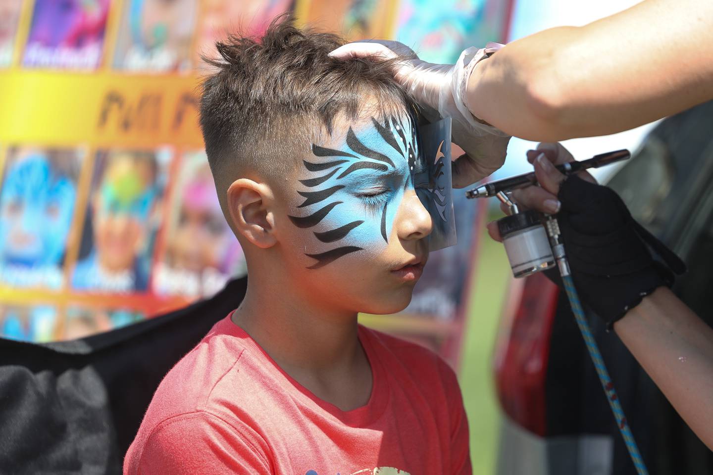 Jimmy Garcia, of Plainfield, gets his face airbrushed at the World of Food Trucks on Saturday, May 18, 2024 at Renwick Community Park in Plainfield