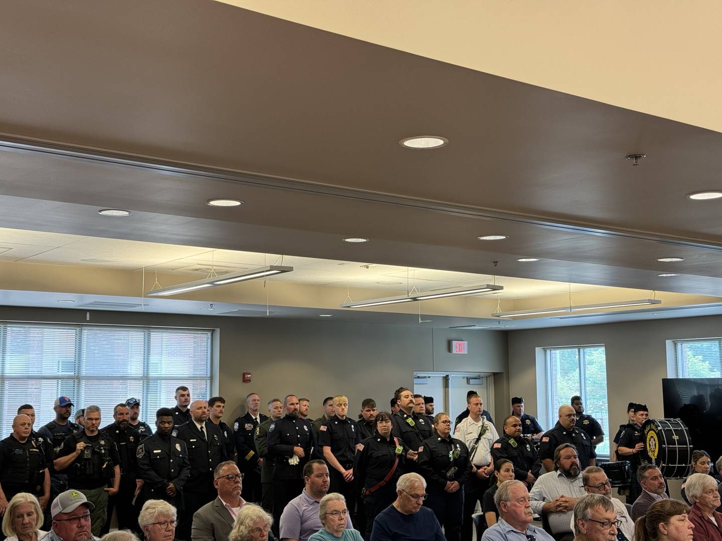 Police and firefighters line the room at Morris City Hall Thursday for the memorial ceremony.