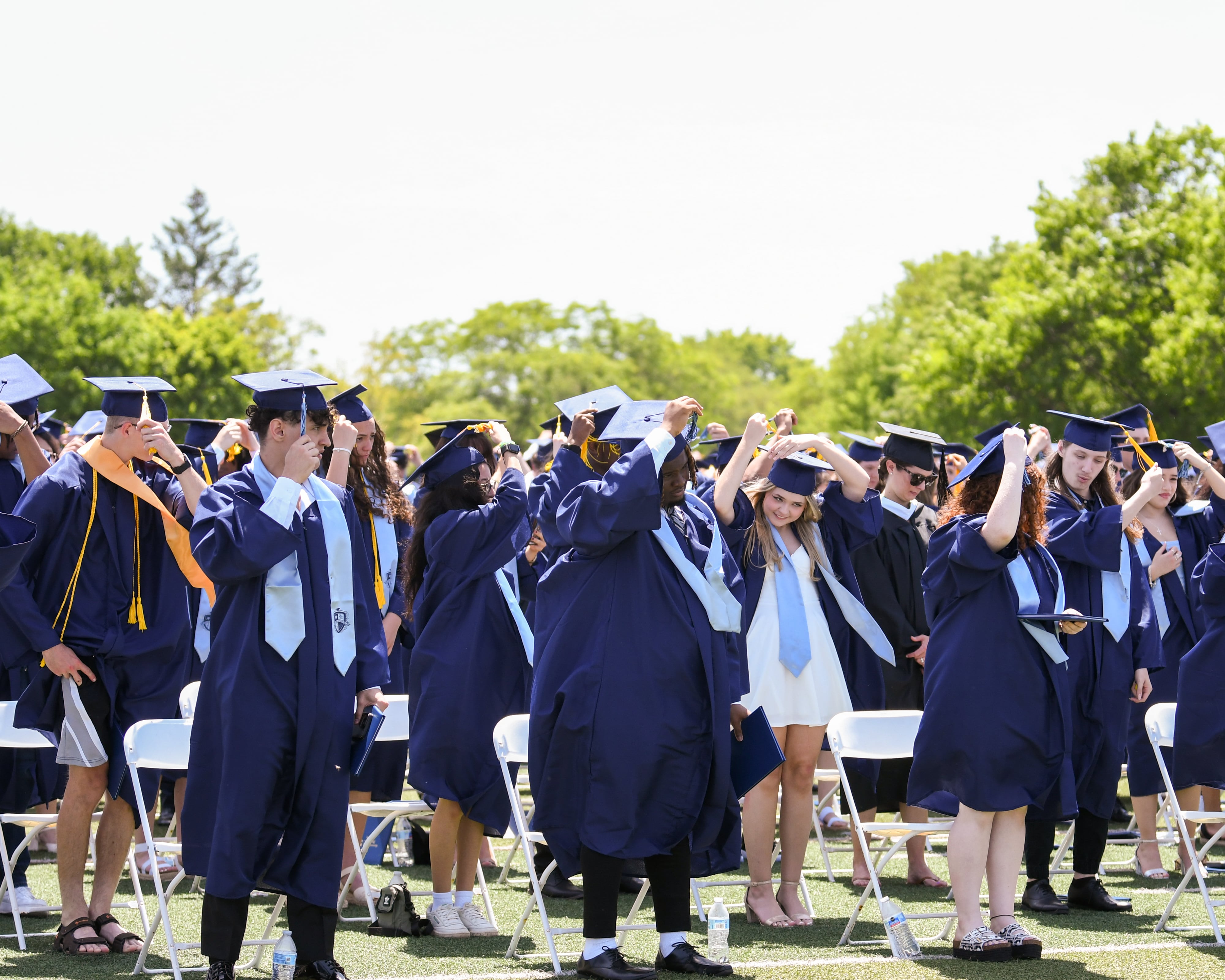 Downers Grove South graduates move their tassels over at the end of graduation on Sunday May 19, 2024, held at Downers Grove South High School.