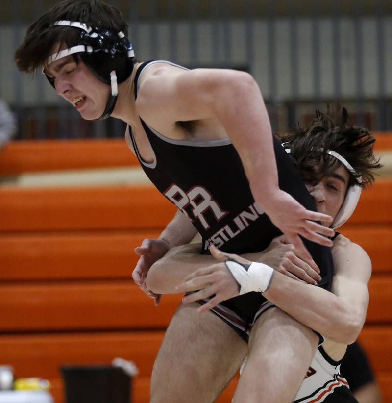 Prairie Ridge’s Milkey Meade tries to get out of the grasp of Kaneland’s Alex Gochis during the 126-pound championship match of a the IHSA 2A Crystal Lake Central Wrestling Regional on Saturday, Feb. 3, 2024, at Crystal Lake Central High School.