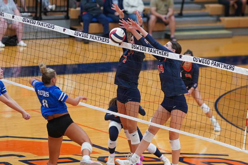 Oswego’s Hannah Herrick (7) and Mia Jurkovic (14) defend the net against a kill attempt by Rosary’s Lily Caruso (6) during a volleyball match at Oswego High School on Tuesday, Sep 3, 2024.