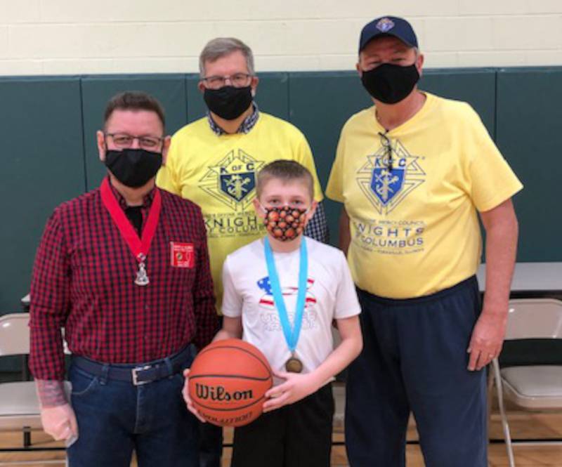 Pictured from left are Rick Llanes, Knights of Columbus District Deputy; Tom Hebert, Yorkville Knights of Columbus Free Throw Contest Chairman; Andrew Madden, 10 year-old  district winner; and Knight Mike Pfeiffer.
