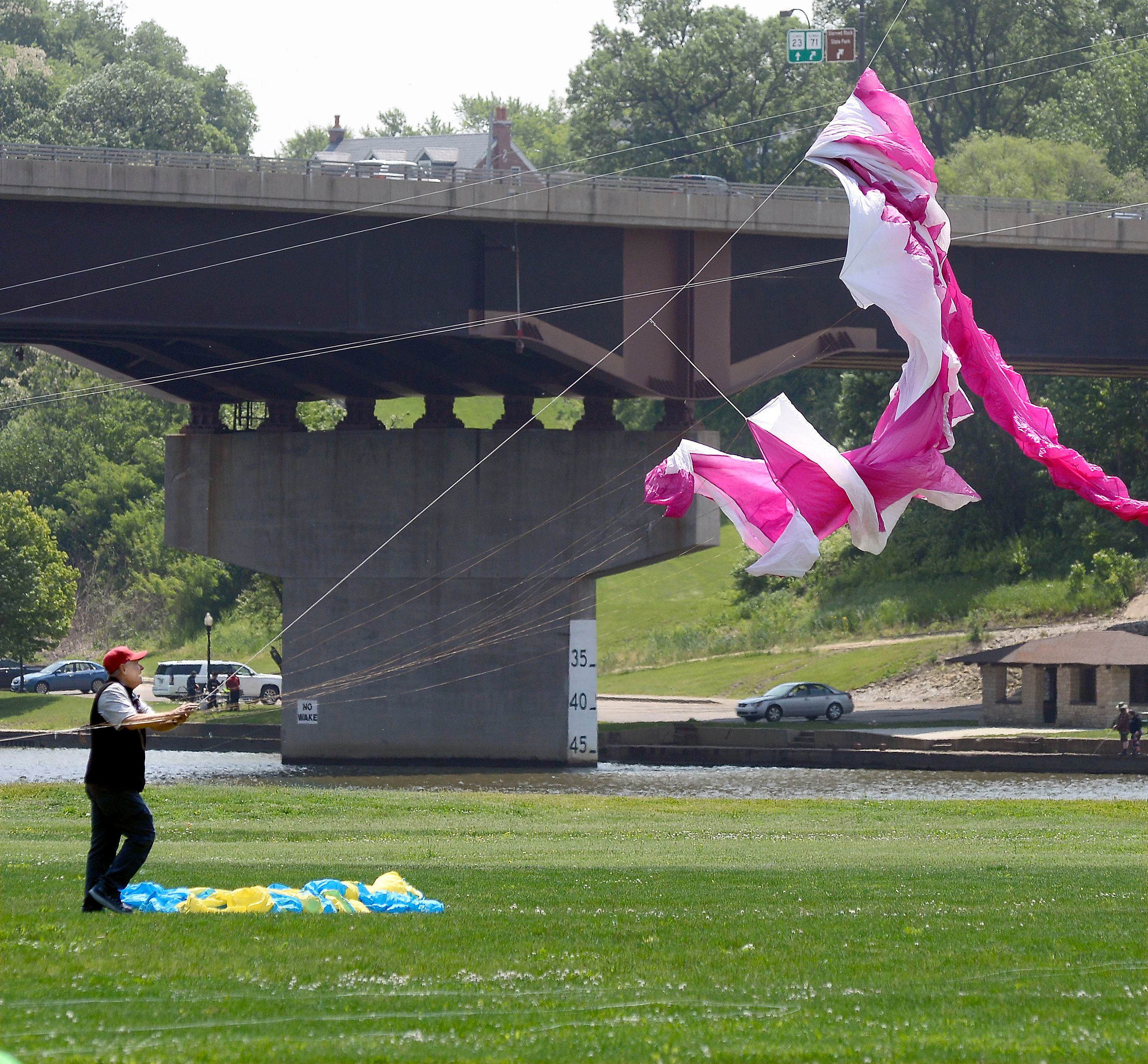 Mike Holl works to untangle his kite Saturday, May 20, 2023, at Riverfront Park in Ottawa during the Kites in Flight festival.