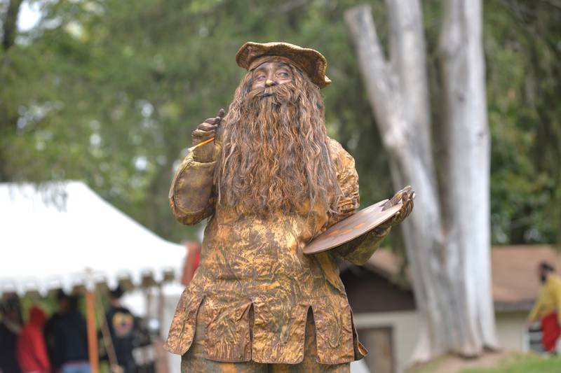 "Cannoli DaVinci", performed by Ginger Whimsy, poses as a statue at Stronghold Conference & Retreat Center during the Olde Engllsh Faire held during Oregon's Autumn on Parade on Sunday, Oct. 8, 2023.