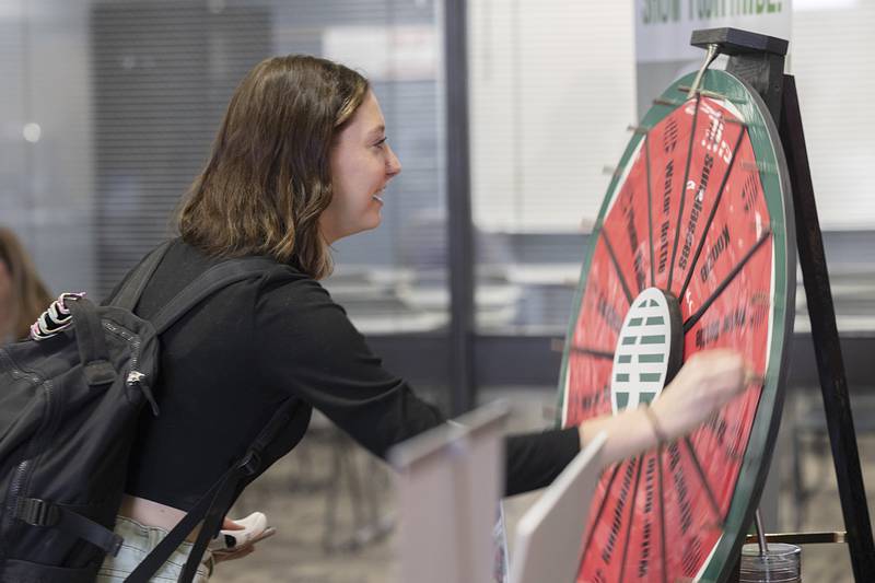 Natalie Tremble of Oregon spins a wheel at the Sauk Valley Bank booth for a change to win a prize Wednesday, Jan. 31, 2024 at Sauk Valley Community College. SVCC held their annual Sauk Fest as a welcome back for the spring semester. Many local businesses and organizations set up booths to inform the students about what they have to offer.