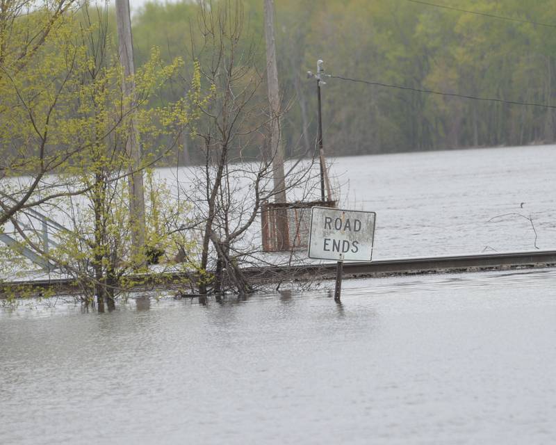 The Mississippi River continued to rise on Sunday flooding streets just west of Main Street in downtown Savanna. The elevated railroad tracks, shown here behind a 'Road Ends' sign, enabled freight trains to continue to pass throw at a much slower pace.