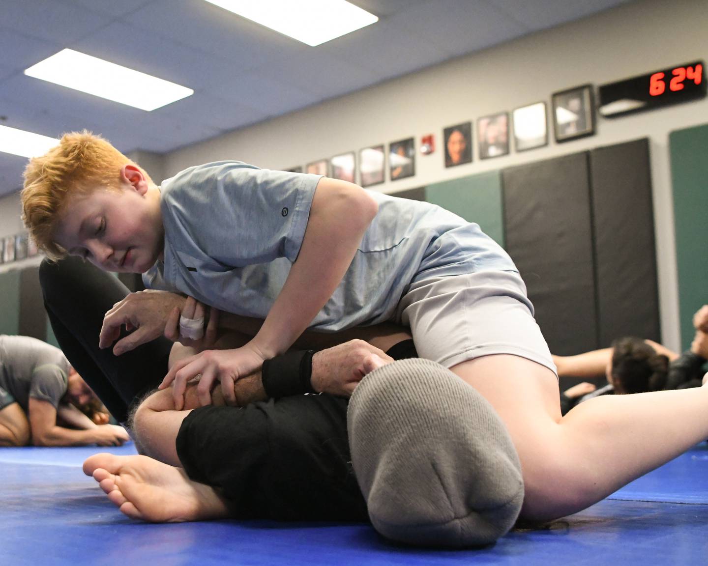 Mason Siemens, 13, of St. Charles tries out the moves he learned during Jiujitsu class at the Misfits on Wednesday March 3, 2024, on Wayne Carlson of Sycamore.