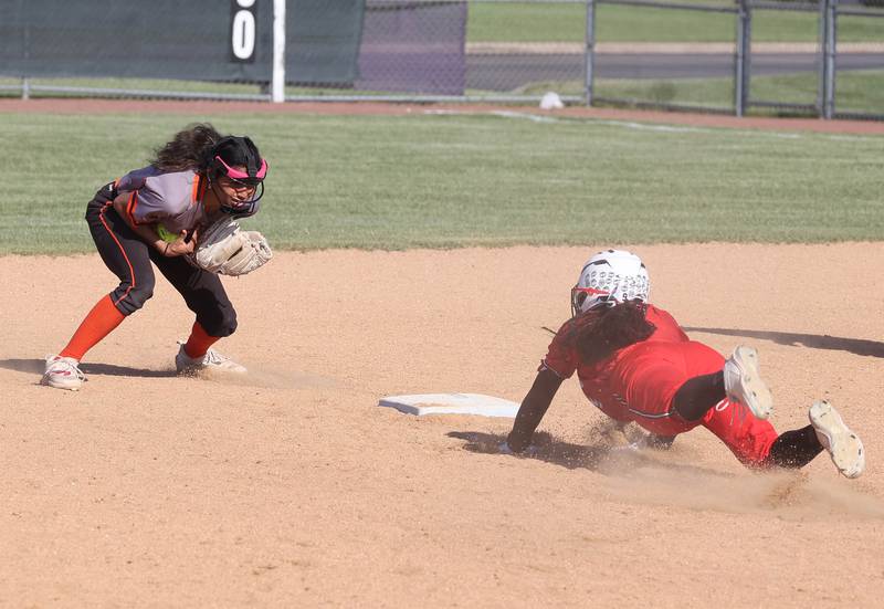 DeKalb's Nazeria  Dean smothers the throw but not in time to get Rockford Auburn's Za'Kayia Hudson diving back to second during their Class 4A regional semifinal game Wednesday, May 22, 2024, at Hampshire High School.