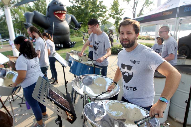 Members of the Culture Arts & Music group entertain with steelpan drums Friday, Aug. 18, 2023, during Julie Ann’s first-ever Ice Cream Fest at Crystal Lake’s Main Beach. The beach was transformed into “Ice Cream Land” with themed areas such as Kong Cove and Blue Moon Bay.