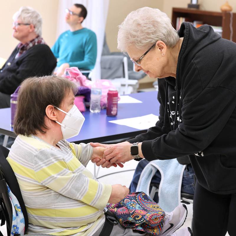 Marilyn Bell, a long-time direct support professional at Opportunity House, helps client Jenny Hott put some lotion on her hands Thursday, Nov. 2, 2023, at the facility in Sycamore. Opportunity House will be celebrating its 60th anniversary Thursday, Nov. 9 at Faranda's Banquets in DeKalb.