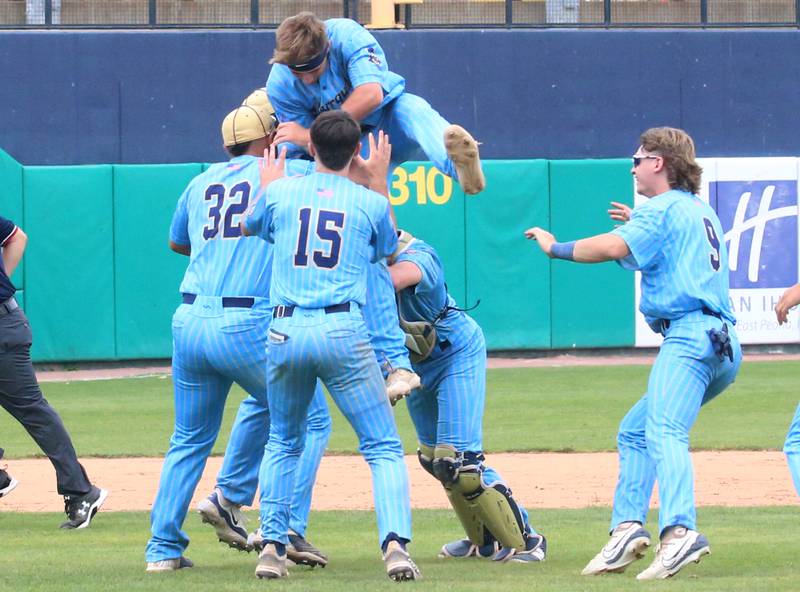 Marquette's Anthony Couch leaps on top of teammates after Altamont to win the Class 1A State championship title on Saturday, June 1, 2024 at Dozer Park in Peoria.