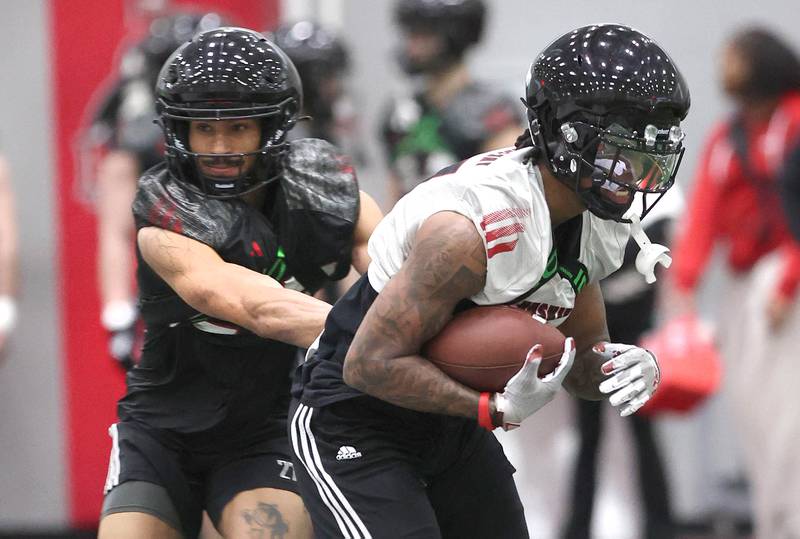 Northern Illinois University receiver Keyshaun Pipkin avoids a defender after making a catch Tuesday, March 26, 2024, during spring practice in the Chessick Practice Center at NIU.