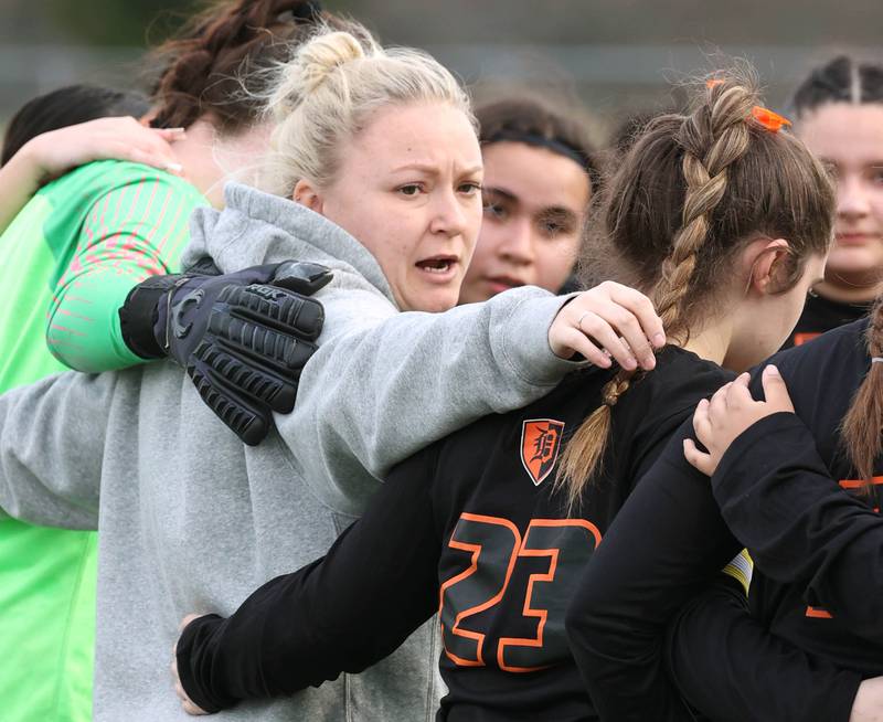 New DeKalb head girls soccer coach Kay Brooks gathers her team before their game against Belvidere North Tuesday, March 12, 2024, at DeKalb High School.