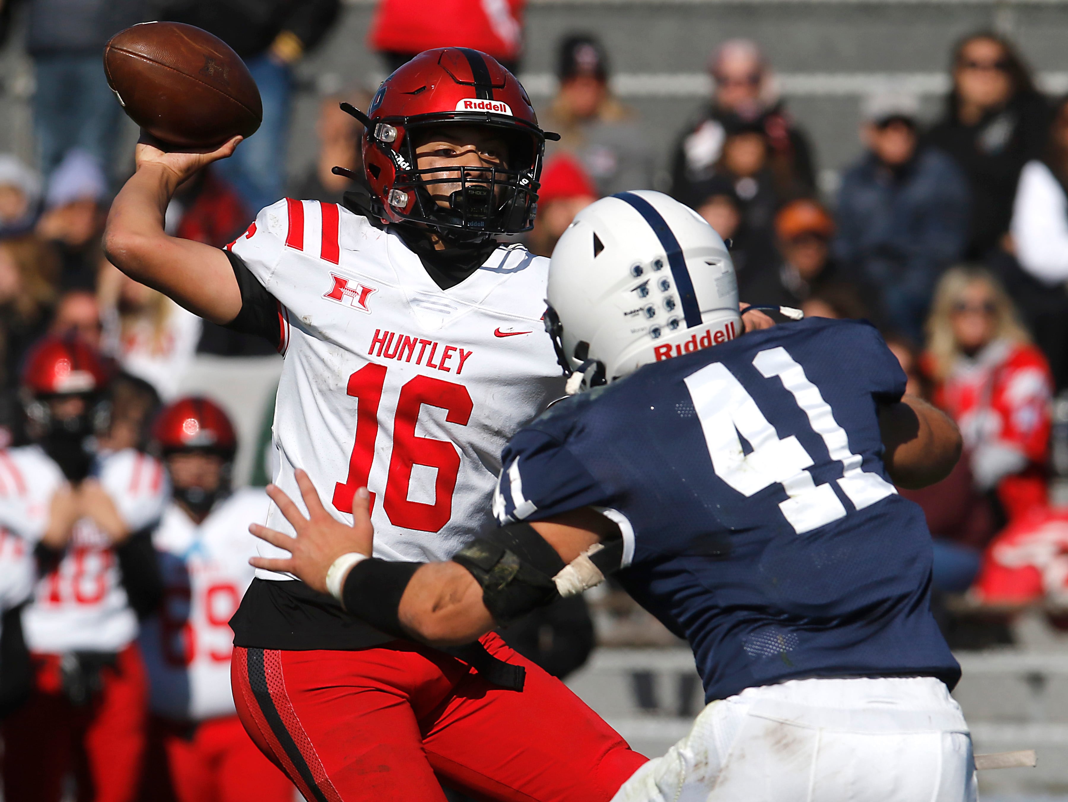 Huntley's Braylon Bower throws a pass a Cary-Grove's Ian Moran rushes during a Fox Valley Conference football game on Saturday, Oct. 7, 2023, at Cary-Grove High School.