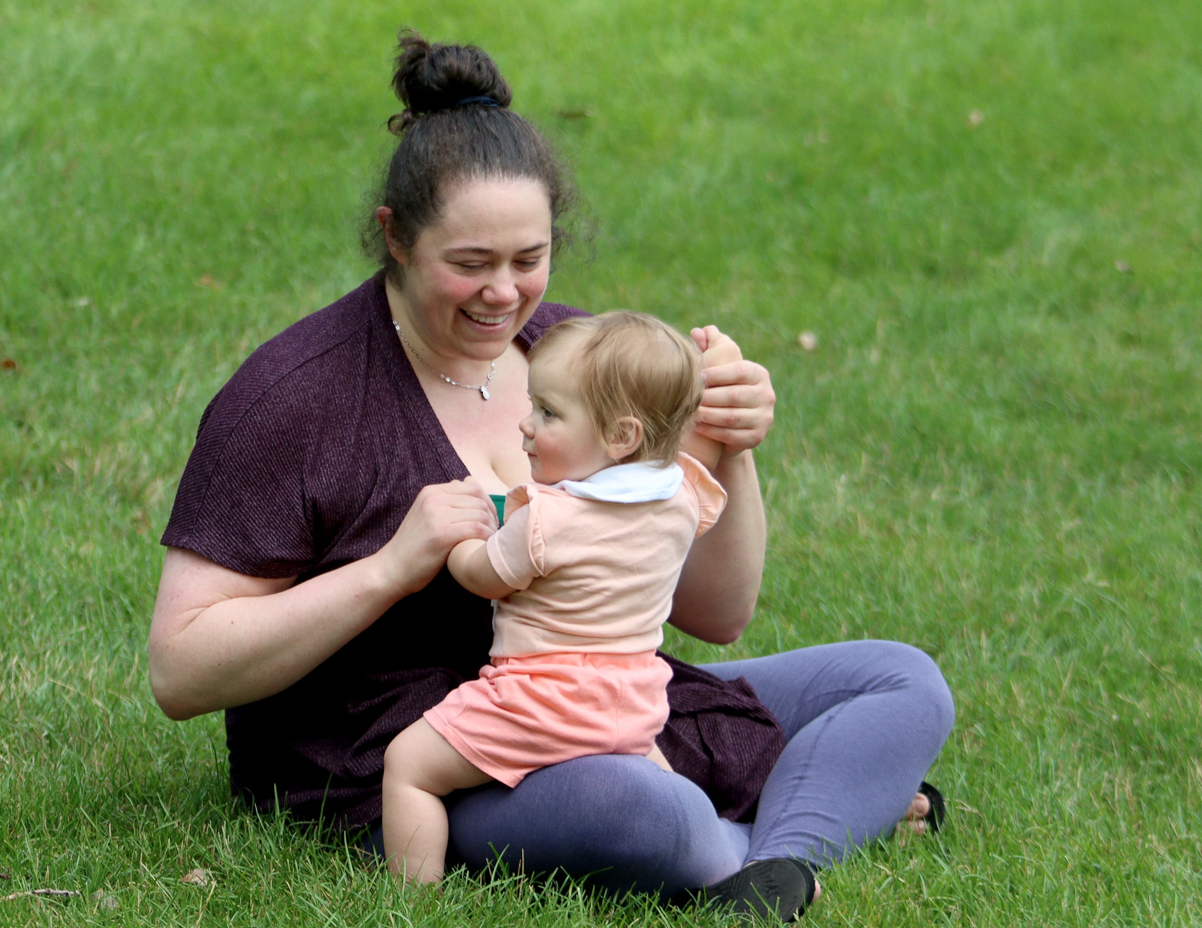 Charis Wajnberg of Algonquin shares a moment with her daughter Elora Philpot, 1, during The Dole Farmers Market in Crystal Lake Sunday.