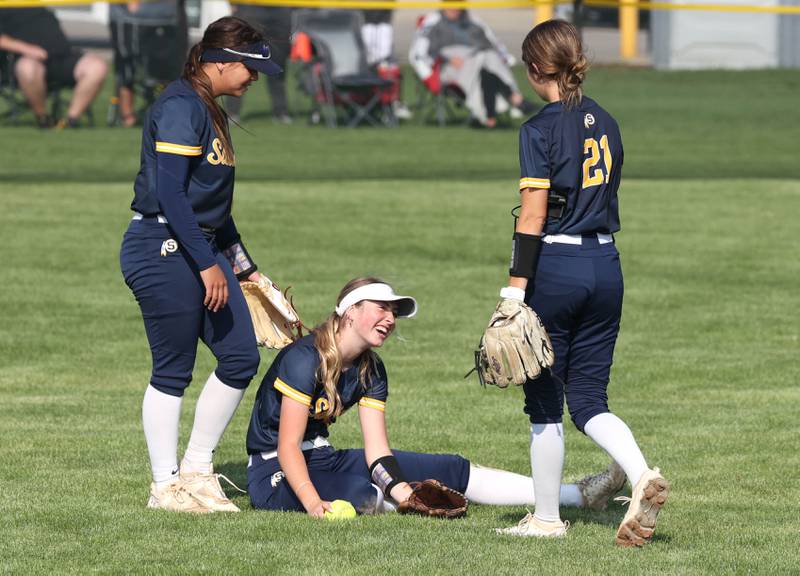 Sterling's Olivia Melcher takes a break between teammates after making a diving catch in center field for the third out of the second inning during their game against Sycamore Tuesday, May 14, 2024, at Sycamore High School.