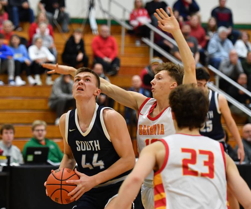 Downers Grove South's Justin Sveiteris (44) looks to shoot while Batavia's Nate Nazos defends during a Jack Tosh Classic game on Dec. 26, 2023 at York High School in Elmhurst.