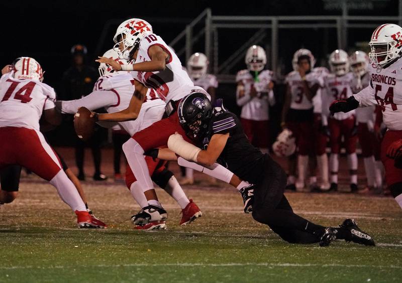 Downers Grove North's Joseph Edwards (8) tackles Kenwood's NaCari McFarland (10) in the backfield for a loss during a class 7A playoff football game at Downers Grove North on Friday, Oct. 27, 2023.