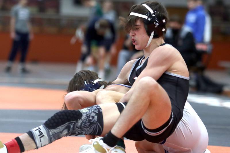 Prairie Ridge’s Tyler Evans, front, won the title bout at 120 pounds over Woodstock’s Caleb Sciame during IHSA Class 2A regional wrestling at Crystal Lake Central Saturday.