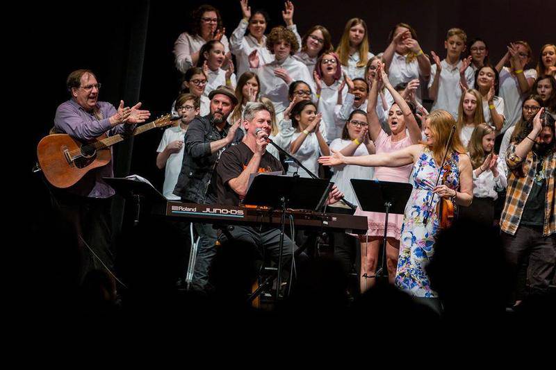 Tim Placher (center) at the microphone, is seen with the cast of last April's "The Tim Placher All-Stars."