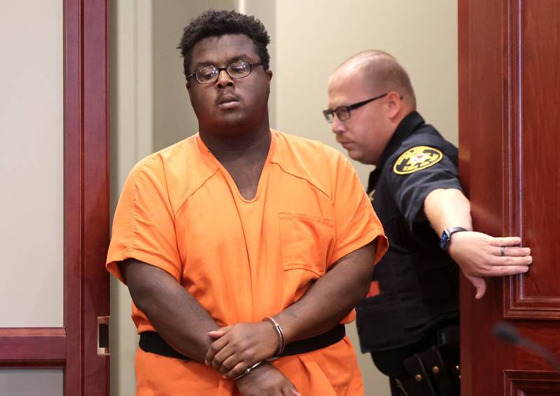 Timothy M. Doll, of DeKalb, is escorted by DeKalb County sheriff’s deputies as he enters a DeKalb County courtroom last year.