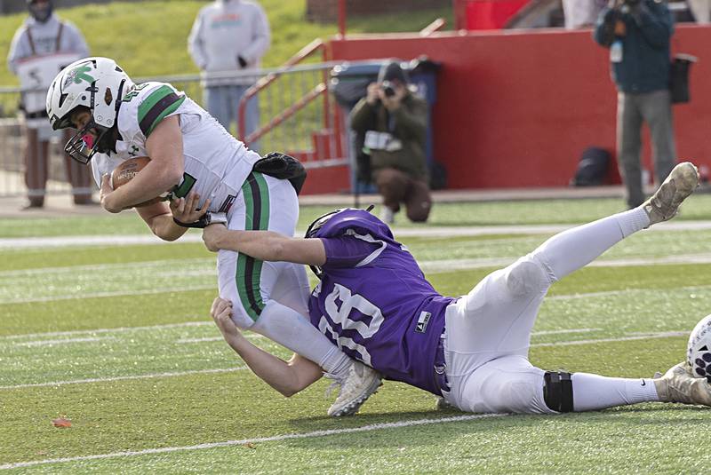 Athens’ Hunter DiGiovanna is hauled down by Wilmington's Joey Cortese Friday, Nov. 24, 2023 in the 2A state football championship game at Hancock Stadium in Normal.