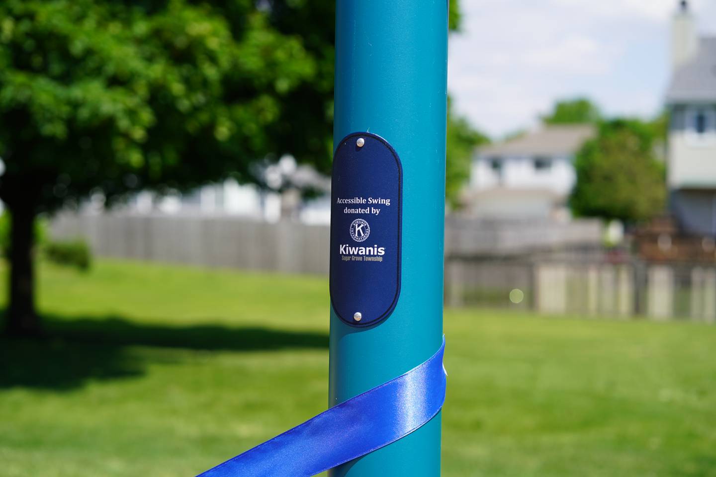 “Accessible Swing donated by Kiwanis" reads the plate on a new swing at Chelsea Park in Sugar Grove.  The Kiwanis of Sugar Grove Township worked with the Sugar Grove Park District on getting the new swing installed.