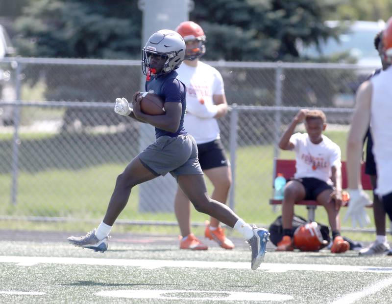 Oswego East’s Jamari Mckay runs with the ball during a 7-on-7 tournament at Batavia High School on Thursday, July 18, 2024.