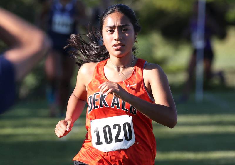 DeKalb’s Brenda Aquino (right) finishes the girls varsity race Tuesday, Sept. 3, 2024, at the Sycamore Cross Country Invite at Kishwaukee College in Malta.