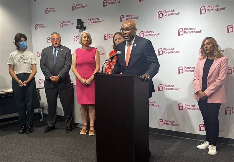 Illinois Attorney General Kwame Raoul stands with fellow abortion rights advocates on Thursday to celebrate the signing of a bill allowing Illinoisans to sue crisis pregnancy centers that engage in “deceptive acts” aimed at deterring abortions.