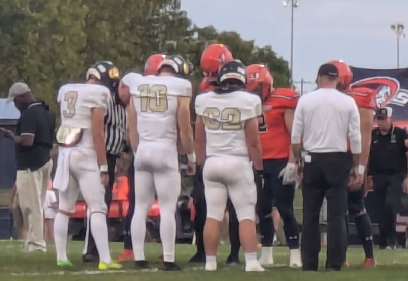 Sycamore and Mahomet-Seymour captains await the result of the coin toss on Friday, Sept. 13 in Mahomet. The Spartans ended up with the 21-13 road win.