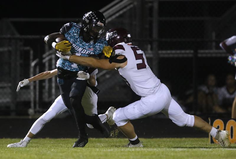 Woodstock North's Sean Mitchell is tackled by Marengo's Brady Kentgen during a Kishwaukee River Conference football game on Friday, Sept. 13, 2024, at Woodstock North High School.