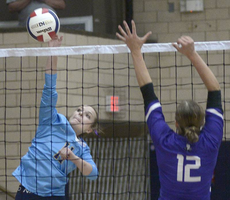 Marquette’s Ava Offermann prepares to get this spike off past Lexington’s Eva McCue in the first match Tuesday at Marquette.