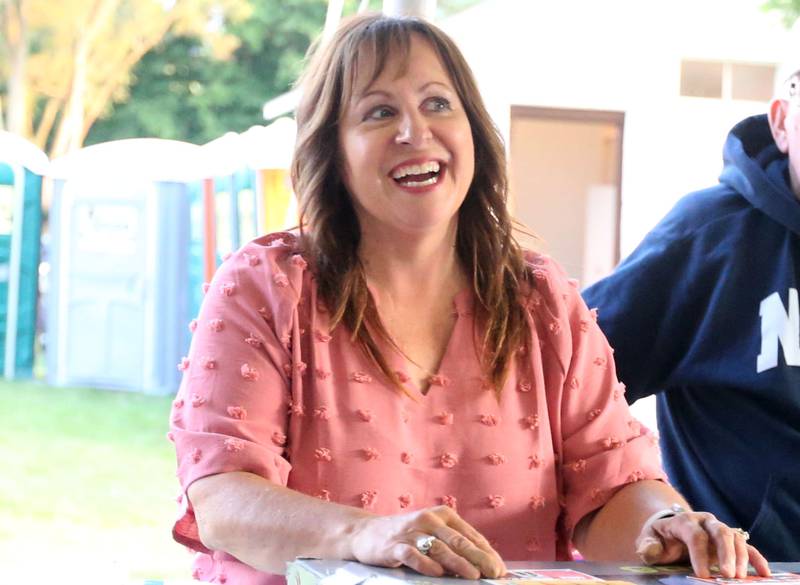 Betty Glynn, organizer for the Cops 4 Cancer fundraiser smiles while running the raffle booth on Friday, July 26, 2024 at Cerri Memorial Park in Cedar Point. Cops 4 Cancer began in 2003. The group helps famlies in their fight against cancer, by providing financial assistance in a variety of ways.