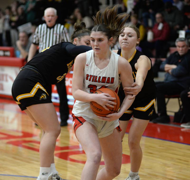 Stillman Valley's Brooke Jordal (34) rips the ball away from two Riverdale players during a Tuesday. Feb. 20, 2024 game at the 2A Oregon Sectional held at the Blackhawk Center at Oregon High School. The Cardinals won the game 57-34 to advance to the sectional championship.