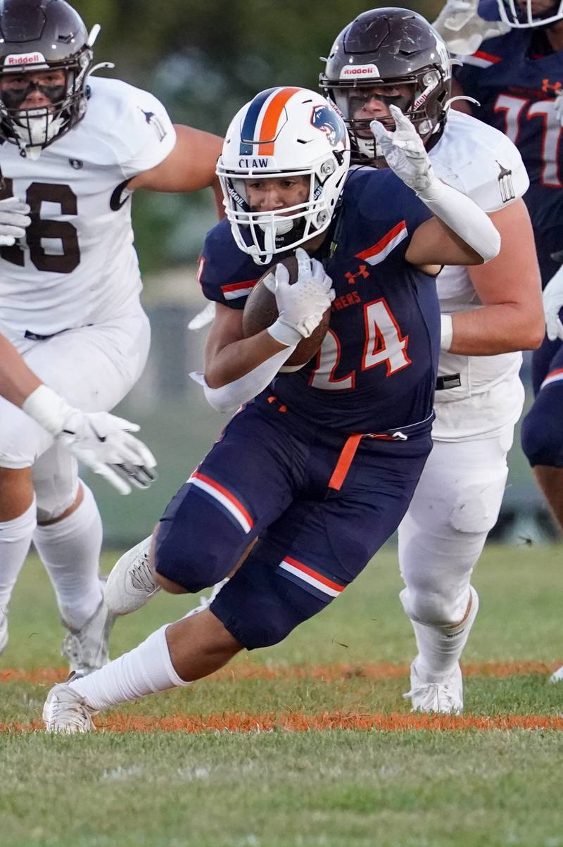 Oswego’s Ayden Villa (24) carries the ball against Joliet Catholic during a football game at Oswego High School on Friday, Sep 6, 2024.