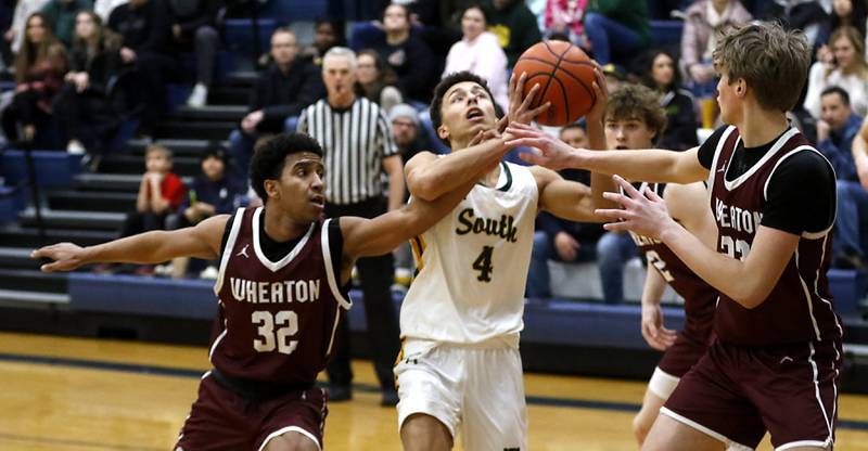 Crystal Lake South's AJ Demirov is founded by Wheaton Academy's Wandy Munoz as Demirov drives to the basket during the IHSA Class 3A Cary-Grove Boys Basketball Regional Championship game on Friday, Feb. 23, 2024 at Cary-Grove High School.