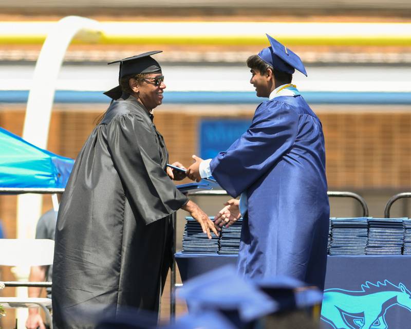 A Downers Grove South Senior is all smiles as he receives his diploma on Sunday May 19, 2024, at Downers Grove South High School.