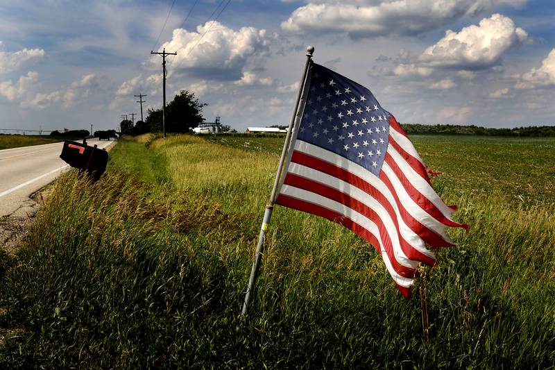 An American Flag flutters in the wind along Hartland Road south of Hartland on Monday, June 17, 2004.