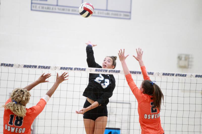 St. Charles North's Haley Burgdorf (23) goes up for a kill during a game against Oswego Wednesday, Sept. 18, 2024 at St. Charles North.