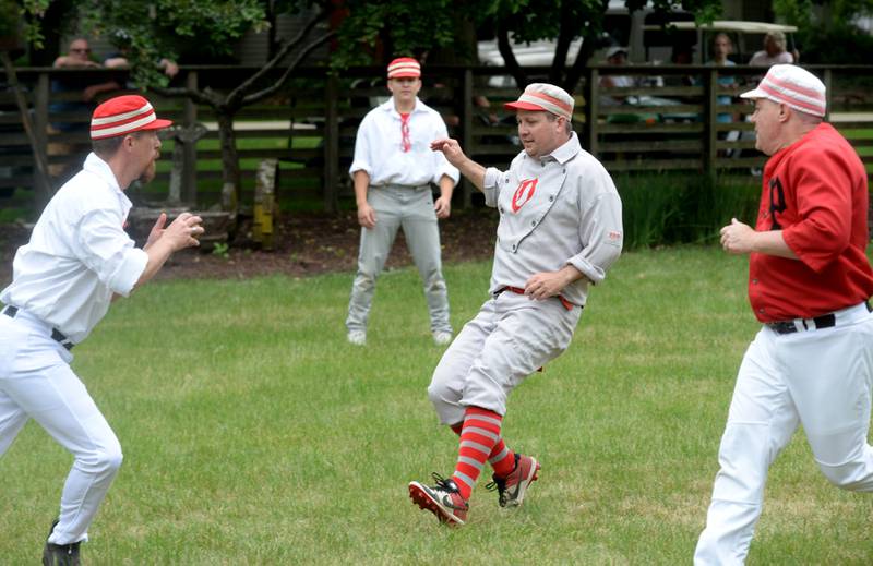 Oregon Ganymede Aaron "Two Bits" Berg prepares to get tagged out by a DuPage Plowboy during a vintage base ball game at the John Deere Historic Site in Grand Detour on Saturday, June 8, 2024.