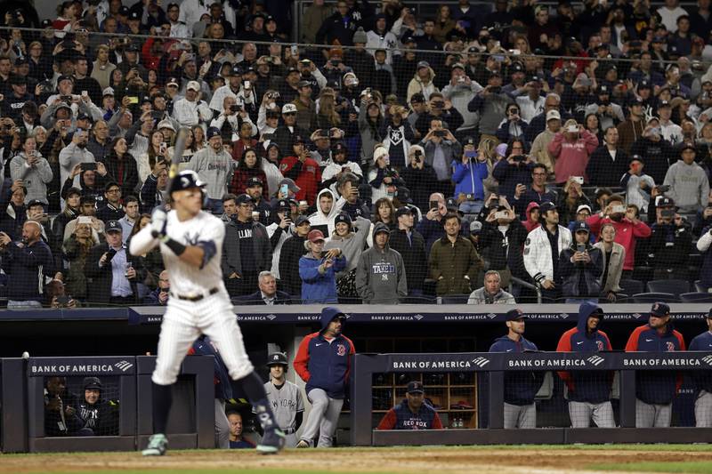 Fans hold up their phones as New York Yankees' Aaron Judge bats during the seventh inning of a baseball game against the Boston Red Sox on Friday, Sept. 23, 2022, in New York. (AP Photo/Adam Hunger)