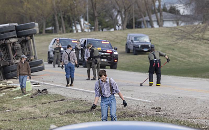 First responders and neighbors work at an accident scene in rural Whiteside County Thursday, March 28, 2024.