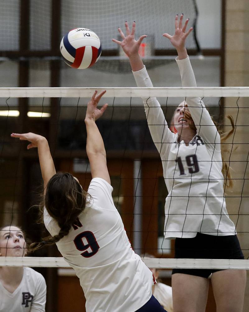 Prairie Ridge's Ashley Stiefer tries to block the quick hit by Belvidere North's Mya Potter during the Class 3A Woodstock North Sectional finals volleyball match on Wednesday, Nov. 1, 2023, at Woodstock North High School.