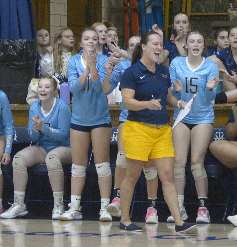 The Marquette Lady Crusader bench celebrates a point against Lexington in the first match Tuesday at Marquette.