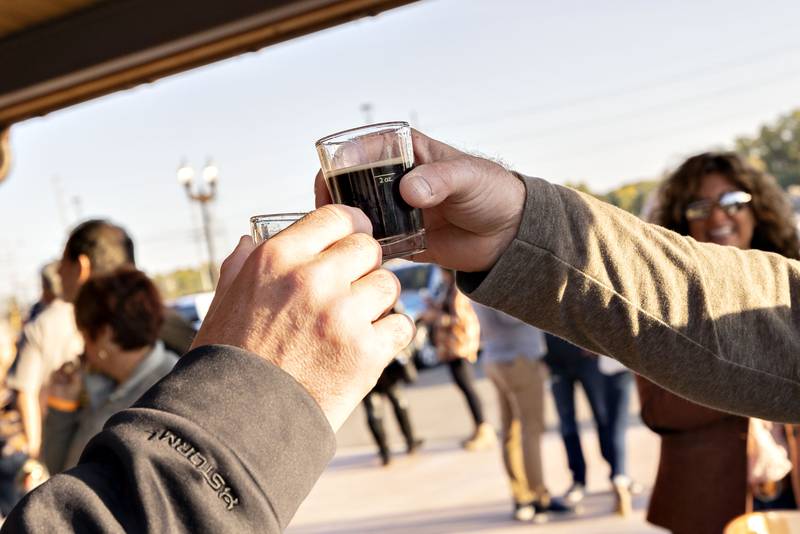 Friends toast one another as they sample some of the interesting beers made available at Hops on the Rock.