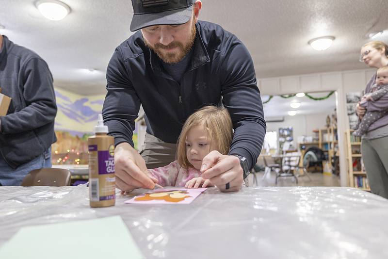 Jake Ackert helps daughter Avery, 3, with a fox craft at the end of the learning portion of the program. In the coming sessions kids will learn about bears, deer and the mouse.